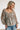 Frontal view of the Above All Else Top that features a blue colored material with a multi-colored floral print, a V neckline, a long sleeve, a ruched bust, and a flowy fit.