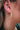 The Better Together Earring is a clear acrylic hoop style earring featuring gold and multi-colored specs through out.