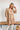 Frontal view of the Count On Me Dress that features an ivory colored material, a multi-colored floral print, a V neckline, a 3/4 sleeve, a button-up front, a tiered design, and a mini length.