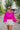 Frontal view of the Go To Girl Top that features a magenta colored material, a round neckline, a long sleeve, a front knot detail at the hem, and a flowy fit.