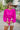 Frontal view of the Go To Girl Top that features a magenta colored material, a round neckline, a long sleeve, a front knot detail at the hem, and a flowy fit.