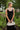 Frontal view of the Call You Mine Midi Dress that features a black colored silk material, a cowl neckline, a sleeveless design with thin adjustable straps, a side slit, and a midi length.