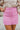 Frontal view of the Think Pink Skirt that features a pink tweed material, a faux button-up front, a back zipper closure, and a mini length.