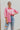 Frontal view of the All Things Lucky Top that features a pink colored material, a collar neckline, a button-up front, a long cuffed sleeve, and a front pocket.