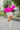 Frontal view of the Go To Girl Top that features a magenta colored material, a round neckline, a long sleeve, a front knot detail at the hem, and a flowy fit.