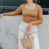 Front view of model wearing the On Your Mind Top in Brown which features light brown knit fabric, cropped waist, round neckline and long sleeves.