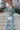 Front view of model wearing the On Your Mind Top in Green which features light green knit fabric, cropped waist, round neckline and long sleeves.