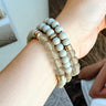The All Natural Bracelet Set features three bracelets, each the same with beige and gold beading through out.
