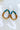 The Irreplaceable Earring is a beaded hoop style earring, featuring a teardrop shape and teal, brown, and gold beading through out.