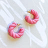 The Twisted Feeling Earring is a hoop style earring, featuring a thick twisted design. 