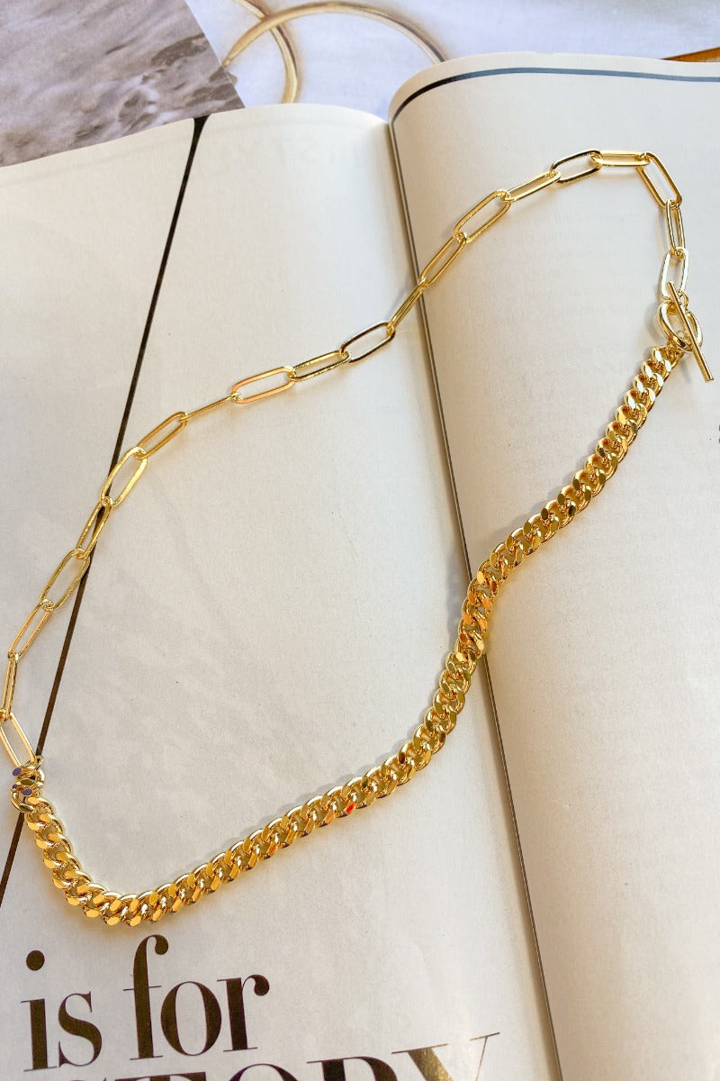 The Maybe My Soulmate Necklace is a gold necklace, featuring two different chains, one side a paper clip chain and the other a curb chain, finished with a hook. 