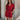 Frontal view of the  Running The Show Denim Romper that features a crimson colored denim with some stretch, a surplice neckline that snaps with a collar, half-length sleeves, a front zipper, pockets, pleating on the legs, and a 3" inseam.