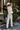 Back view of model wearing The Pretty In Pink Jacket features a pink wool material, an ivory plaid pattern, a collar neck, a button-up front, long cuffed sleeves, two front pockets, and a cropped fit.