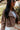 Front view of model wearing the Yellowstone Cropped Denim Jacket features brown denim, a collared neckline with draped lapels, two side slit pockets, long sleeves, and a cropped fit.
