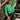 Front view of model wearing The Lucky Me Sweater features a green knit material, a scoop neck, long sleeves, ruffle detailing at the front sides, and a thick bottom hem.