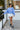 Front view of model wearing The Blake Cropped Sweatshirt In Indigo features knit fabric with a soft fleece interior, a round neckline, long batwing sleeves, and a wide cropped fit.