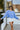 Front view of model wearing The Blake Cropped Sweatshirt In Indigo features knit fabric with a soft fleece interior, a round neckline, long batwing sleeves, and a wide cropped fit.
