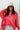 Front view of model wearing the Best Of Luck Sweatshirt In Pink features knit fabric with terrycloth paneling, long raglan sleeves, raw hem details, and a high-low hemline with side slits. 