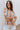 Front view of model wearing the In The Groove Top, which features a blue, pink, orange, and yellow floral print, long balloon sleeves with elastic trim , a square neckline, and a flowy babydoll fit