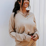 Front view of model wearing the Get Cozy Top, which features a sand-colored knit material, a collar neck, a 3/4 button-up front, long sleeves, and a loose fit. Tucked into matching shorts.