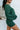 Side view of model wearing the Headed North Shorts, which feature hunter green fabric with horizontal stitched stripes and an elastic waist