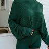 front view of model wearing the Headed North Shorts, which feature hunter green fabric with horizontal stitched stripes and an elastic waist