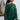 Front view of model wearing the Headed North Top, which features hunter green fabric with horizontal stitched stripes, a round neckline, long sleeves, and a wide cropped fit.