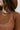 Close-up front view of model wearing the West Coast Sweater, which features open-knit fabric, a round rolled-hem neckline, long sleeves with ribbed elastic wrists, and a cropped back with a tie at the hemline