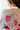 Close-up back view of the Full Bloom Cardigan, which features a grey colored knit material, a multi-colored floral pattern, a V neckline, a button-up front, and long sleeves