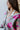 Close-up frontal side view of the Full Bloom Cardigan, which features a grey colored knit material, a multi-colored floral pattern, a V neckline, a button-up front, and long sleeves