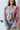 Front view of the Full Bloom Cardigan, which features a grey colored knit material, a multi-colored floral pattern, a V neckline, a button-up front, and long sleeves
