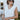 Front view of model wearing the Aspen Sweater Vest, which features ribbed knit ivory fabric, a v-neckline, and a slight high-low hemline with side slits. Vest is styled tucked up.