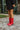 Side view of modeling wearing The Red Hot Western Boot which features faux leather, western stitching, and a 2" heel. These boots run small, we suggest sizing up half a size! 