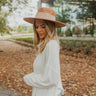 Side view of model wearing The For Everyday Sweater which features soft ivory ribbed fabric with a turtleneck, long sleeves, and a flowy fit.