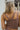 Back view of model wearing The Work It Out Tank which features soft mocha-colored ribbed fabric, two thick straps on each shoulder, and a cropped waist.