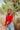 Front view of model wearing the New Day Mock Neck Top, which features red ribbed knit fabric with a mock neckline, long sleeves, and a cropped waist