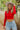 Front view of model wearing the New Day Mock Neck Top, which features red ribbed knit fabric with a mock neckline, long sleeves, and a cropped waist