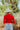 Back view of model wearing the New Day Mock Neck Top, which features red ribbed knit fabric with a mock neckline, long sleeves, and a cropped waist