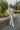 Full body view of model wearing The Ready to Go Shacket which features color-blocked grey and tan corduroy fabric, a button-up front with a collared neckline, long sleeves with buttoned wrists, front chest pockets, and side pockets.