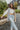 Close view of model wearing The Ready to Go Shacket which features color-blocked grey and tan corduroy fabric, a button-up front with a collared neckline, long sleeves with buttoned wrists, front chest pockets, and side pockets.