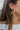 Close side view of model wearing the On Your Own Hoop Earring, which features large open gold hoops.