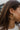 Close side view of model wearing the On Your Own Hoop Earring, which features large open gold hoops.