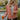Close view of model wearing The Keep Me Warm Quilted Jacket which features quilted terracotta-colored fabric, two large front pockets, and a snap-up front with a collared neckline.