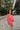 Full body view of model wearing The Cozy Chenille Sweater which features pink chenille fabric, long drop-shoulder balloon sleeves with ribbed wrists, a rolled hemline, and a ribbed v-neckline. The sweater is tucked. 