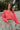 Close up view of model wearing The Cozy Chenille Sweater which features pink chenille fabric, long drop-shoulder balloon sleeves with ribbed wrists, a rolled hemline, and a ribbed v-neckline. The sweater is tucked. 