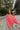 Full body view of model wearing The Cozy Chenille Sweater which features pink chenille fabric, long drop-shoulder balloon sleeves with ribbed wrists, a rolled hemline, and a ribbed v-neckline.