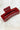 Side view of the Harper Hair Clip in Cranberry, which is a dark red rectangular plastic clip with claw teeth.