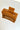 Aerial view of the Harper Hair Clip in Cognac, which is a light brown rectangular clip with claw teeth.