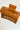 Aerial view of the Harper Hair Clip in Cognac, which is a light brown rectangular clip with claw teeth.