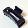 Side view of the Harper Hair Clip in Navy, which is a rectangular clip with claw teeth.